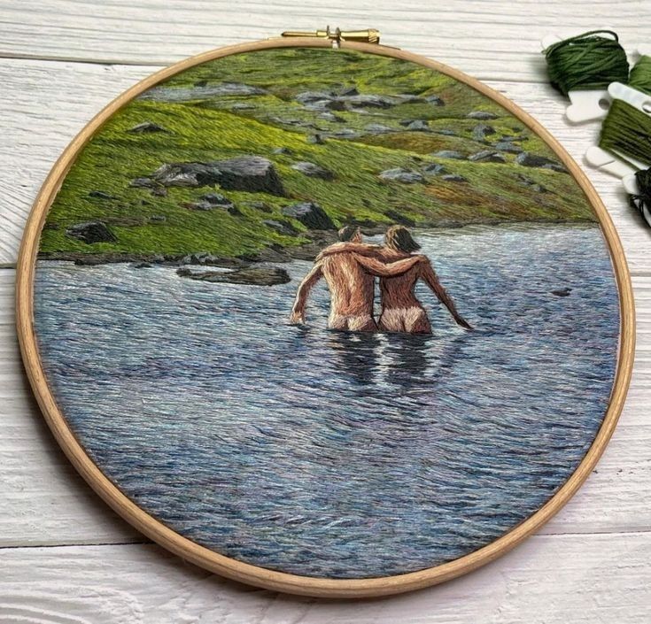 two people standing in the water with their backs to each other, while they are holding hands