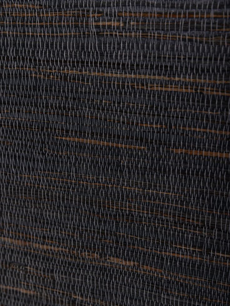 a close up view of a black wall with brown lines