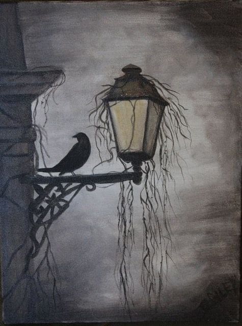 two birds are perched on a lamp post