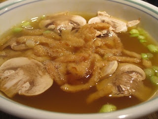 a white bowl filled with soup and mushrooms