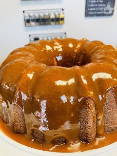 a bundt cake covered in caramel sauce on a white plate