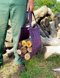 a person holding a bag with logs in the background