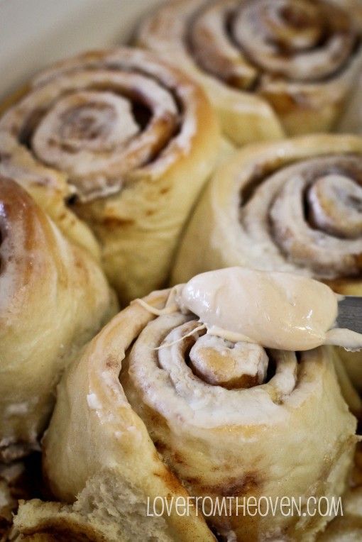 there are some cinnamon rolls with icing on them