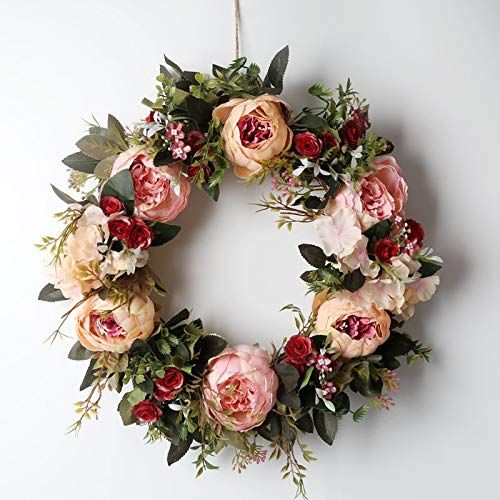 a floral wreath hanging on the wall