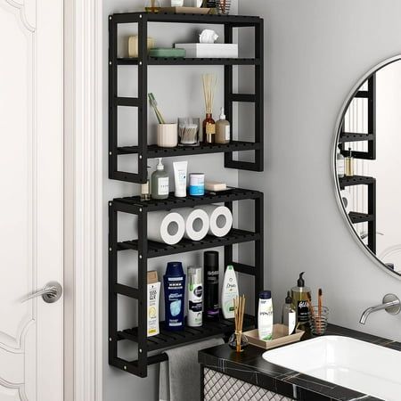 a bathroom with a sink, mirror and shelving unit on the wall in front of it