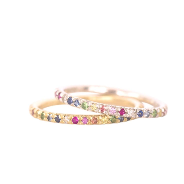 Please note our small workshop is closed for a summer break, so orders placed now will be delivered around 20th September.  Beautiful and elegant sterling silver or 14ct gold rainbow eternity ring, featuring a kaleidoscope of gemstones, made up of pink, white, yellow, orange and blue sapphires, rubies and green tsavorites.  Available in either a half eternity ring or full eternity ring.  Details:  Material: 14ct Gold | AU585 or Sterling Silver | AG925 Gemstone: 0.15ct (half eternity ring) Gemstones: 0.30ct (full eternity ring) Please note our small workshop is closed for a summer break, so any ring order placed now will not be delivered until early October. Sizes are listed as UK ring sizes, if you require a different size than those listed or want to order a US or European ring size pleas Rainbow Gemstone Stackable Rings For Anniversary, Rainbow Sapphire Ring Fine Jewelry Gift, Rainbow Sapphire Ring As Gift, Rainbow Sapphire Ring For Gift, Rainbow Multi-stone Stackable Promise Rings, Rainbow Multi-stone Stackable Rings For Promise, Multicolor Sterling Silver Stackable Rings, Multicolor Multi-stone Stackable Fine Jewelry Rings, Multicolor Stackable Eternity Band As Gift