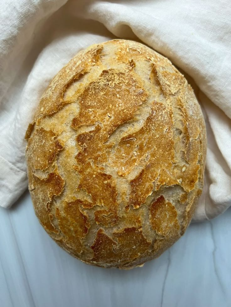 a loaf of bread sitting on top of a white cloth