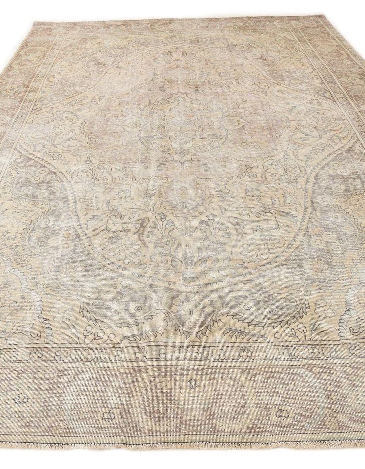 an antique rug is shown on a white background with light colored colors and intricate designs