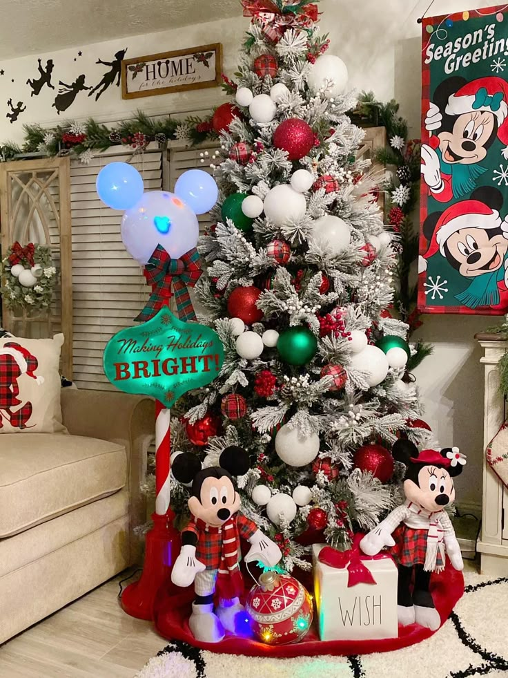 a christmas tree decorated with mickey mouse ornaments