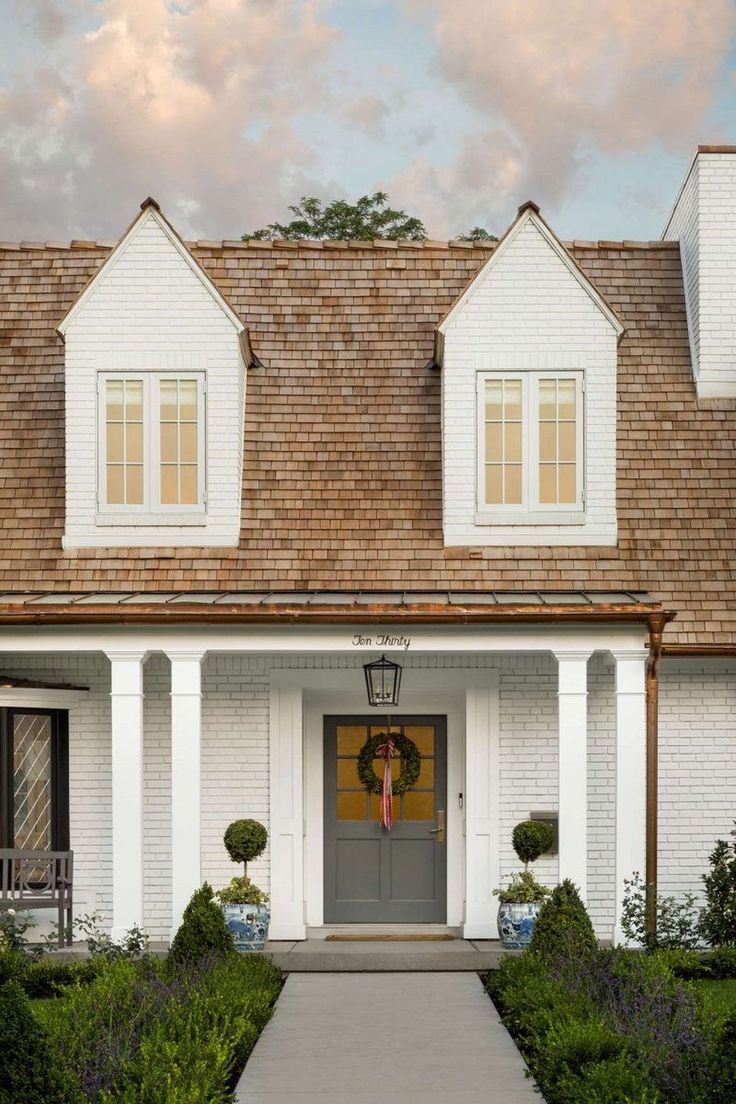 the instagram page shows an image of a white house with brown shingles on it