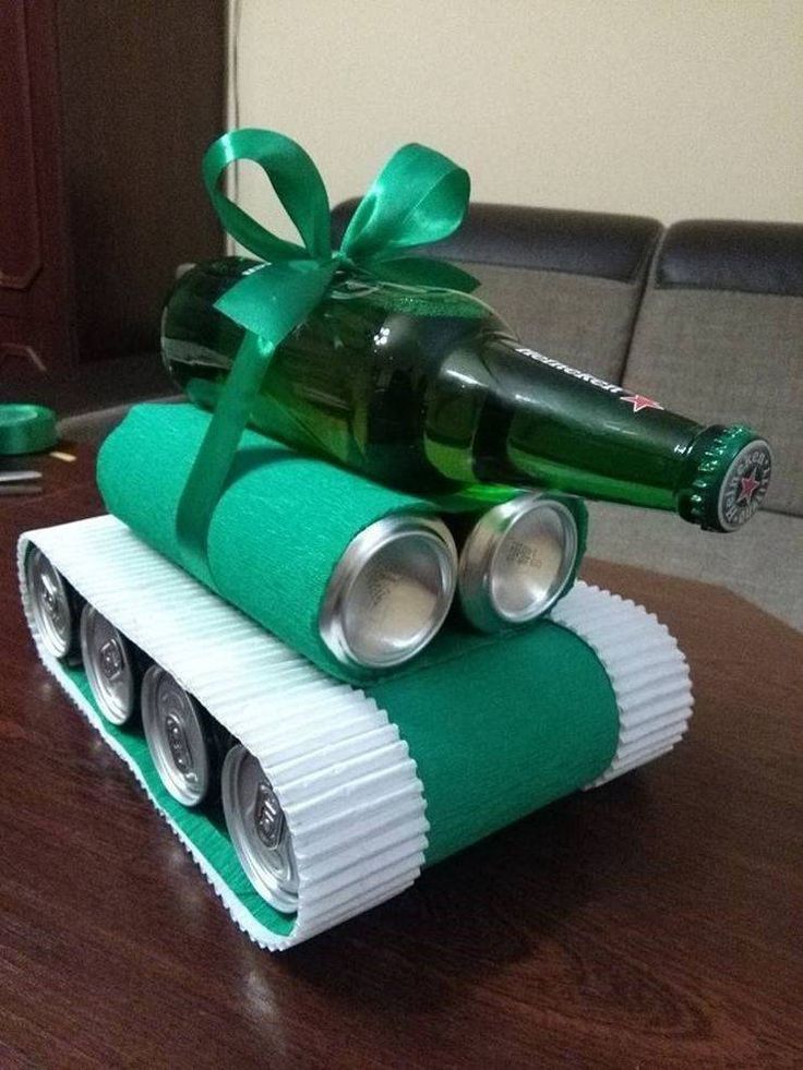 a beer bottle sitting on top of a tank made out of rolled up toilet paper