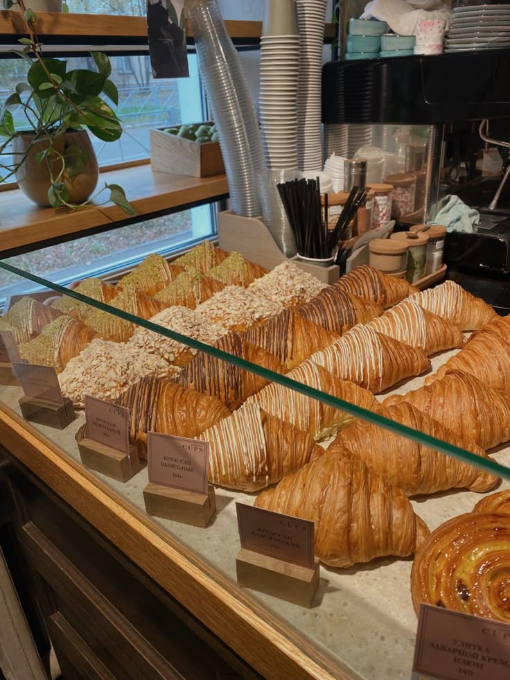 a display case filled with lots of different types of breads and pastries next to each other