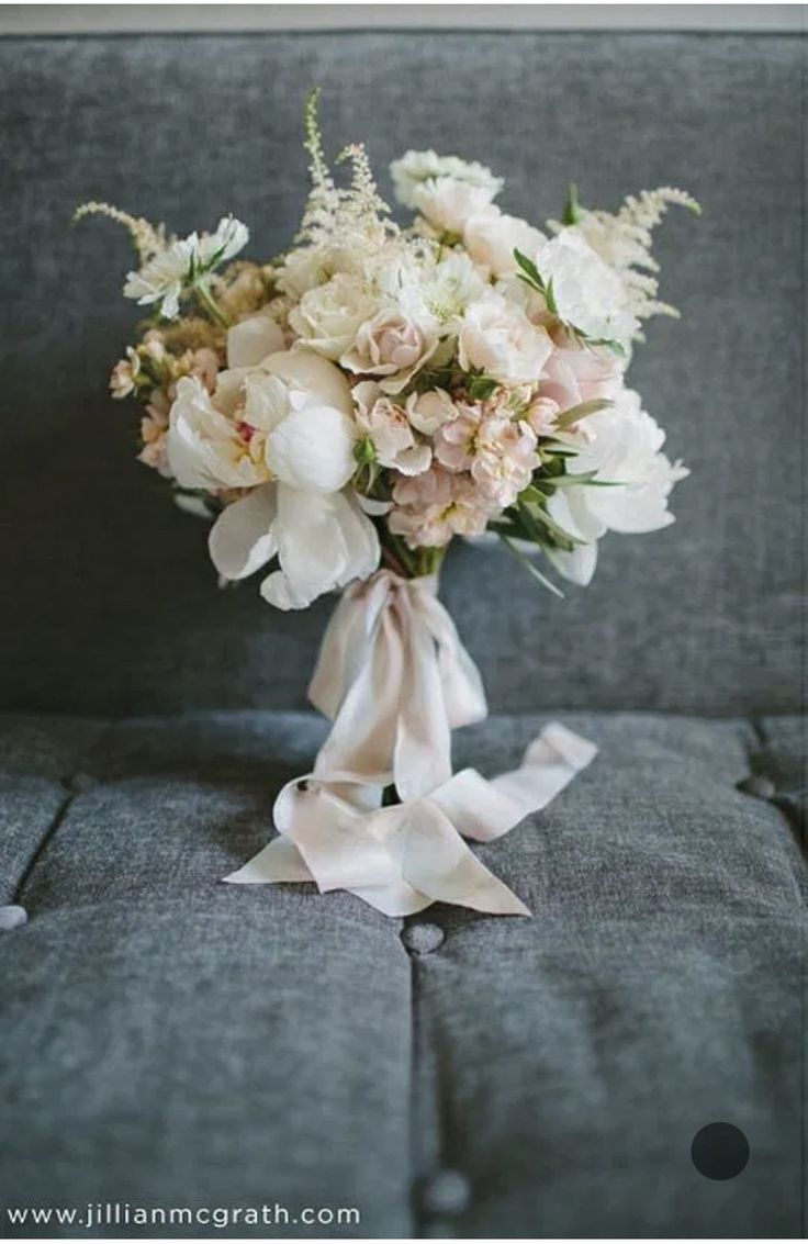 a bouquet of flowers sitting on top of a couch