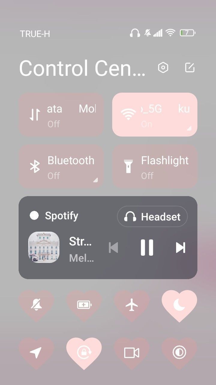 an iphone screen with the control center button highlighted in pink and grey colors, including hearts