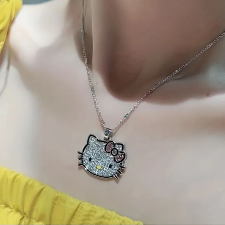 a hello kitty necklace is displayed on a mannequin