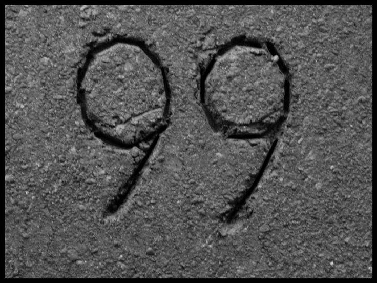 the number nine is drawn in sand