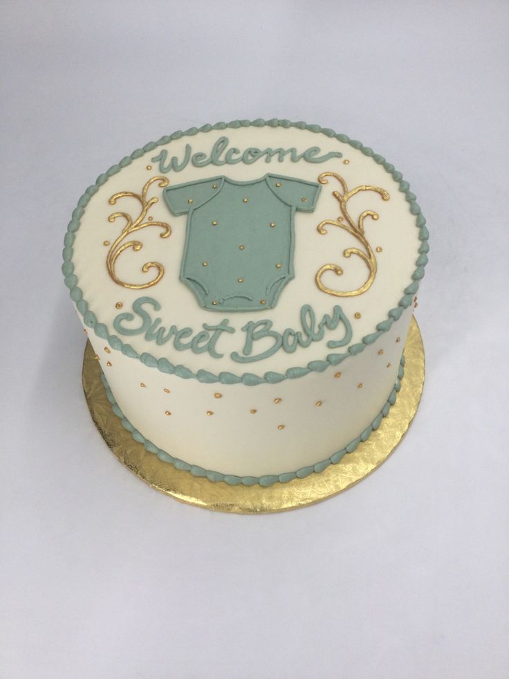 there is a cake that says welcome to sweet baby on the bottom and gold trimmings