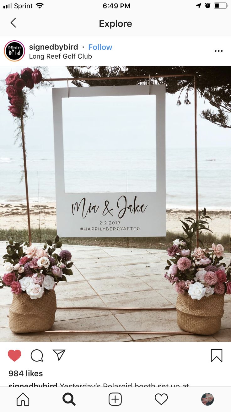 two flower pots sitting on top of a sidewalk next to an open air sign that says mr and mrs