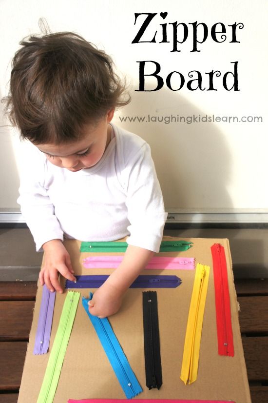 a young child sitting at a table with some colored sticks on it and the words zipper board above them