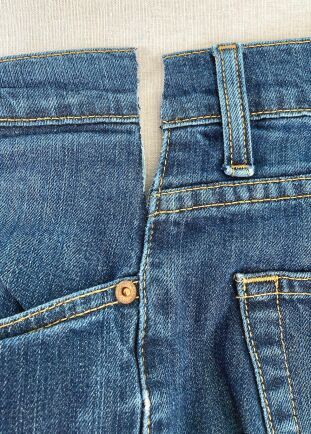 a pair of blue jeans with buttons on them