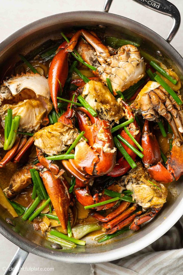 a pan filled with cooked crabs and green beans