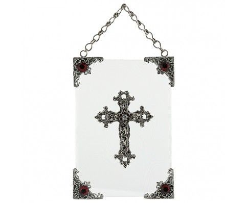 a cross hanging from a chain on a white wall in front of a white background