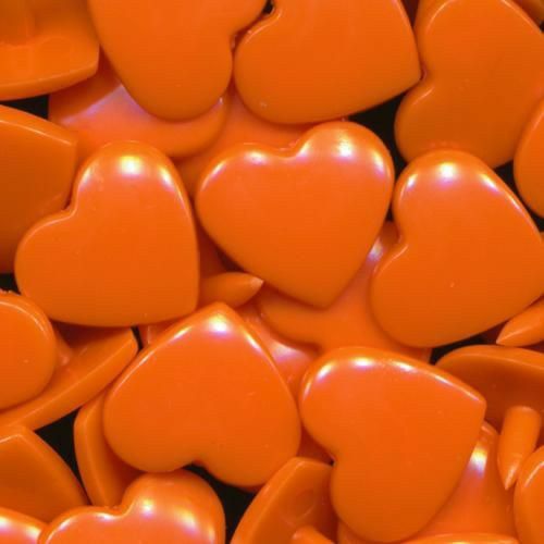 closeup of orange heart shaped candy candies