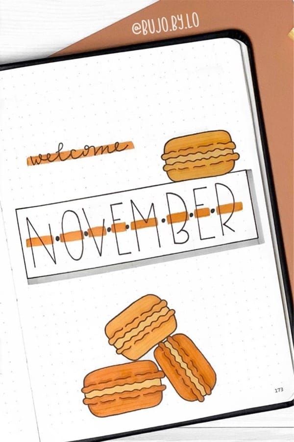 an open notebook with the words november written on it and some cookies in front of it