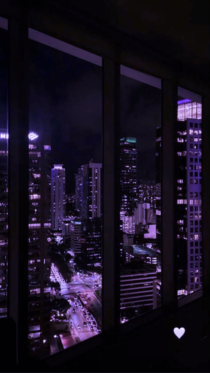 the city is lit up at night with lights shining on it's buildings and skyscrapers