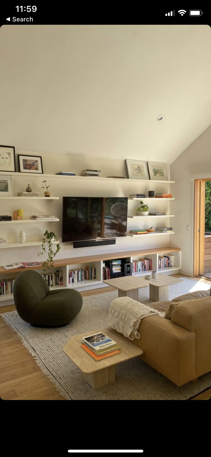 a living room filled with furniture and a flat screen tv