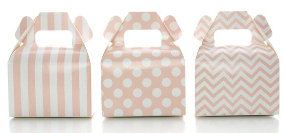 three pink boxes with white polka dots and chevron stripes on the front, one is empty