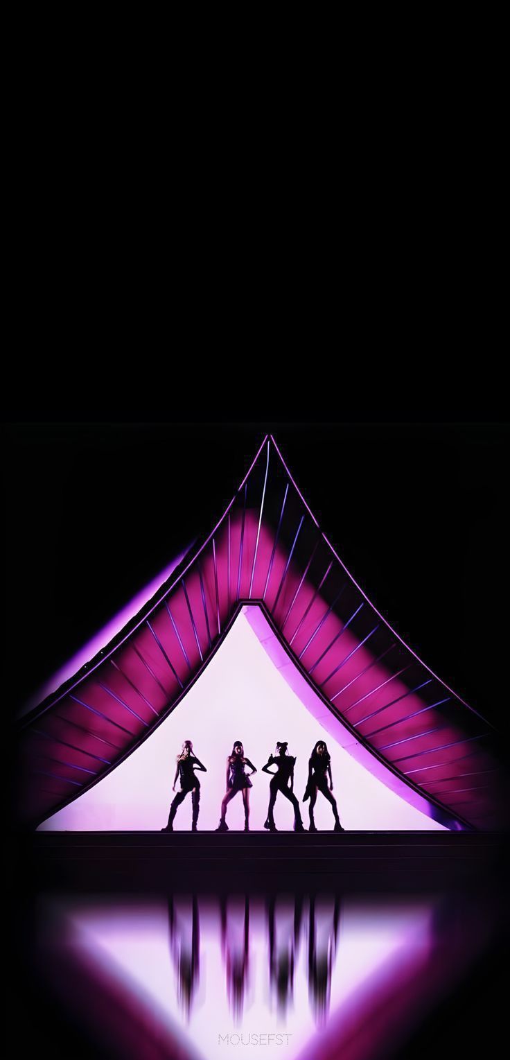 the silhouettes of four people are dancing in front of a large tent with purple lighting