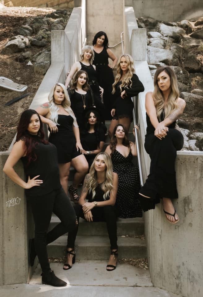 a group of women sitting on top of an escalator next to each other