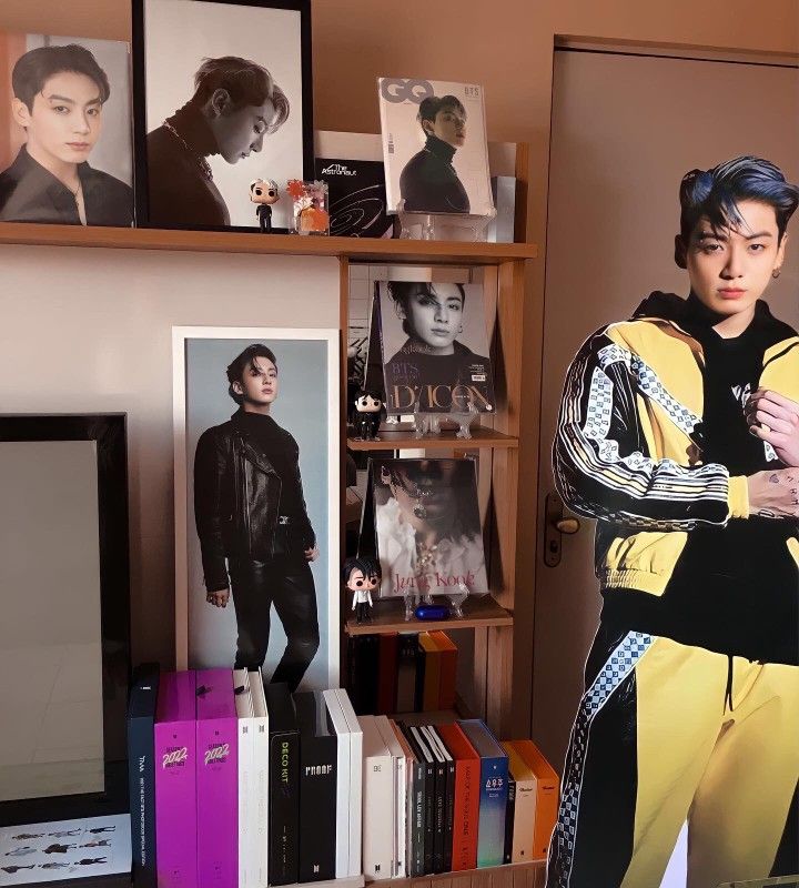 a young man standing in front of a tv