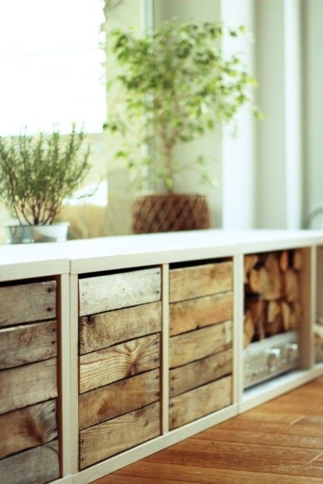 there is a plant in the window sill on top of this cabinet that's made out of wood