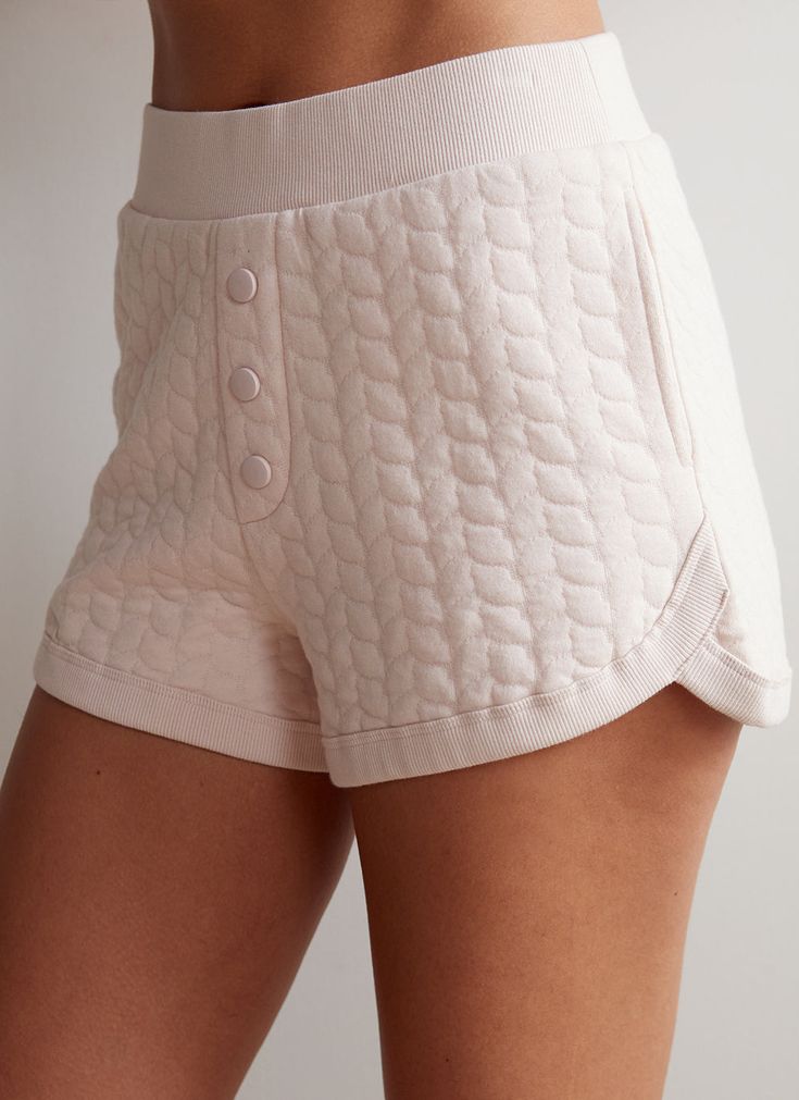 Quilted and cozy, these slip-on shorts are the perfect chilled-out staple piece. Even better? They pair with the Teddi Pullover for a match (set) made in heaven! How it fits: Easy, true to size fit. Sits close to body at waistband.﻿How to style: ﻿Pairs perfectly with a sweater for a cozy night in Material: Cotton, PolyesterContent: 75% Cotton 25% Recycled PolyesterStretch: LightLength: Regular Fit: Relaxed FitFeel: SoftTexture: MediumLined: Unlined Color: White and Pink Neutral Loungewear, Teddy Bear Fabric, Bear Fabric, Lounge Looks, Loungewear Dresses, Spring Knits, Winter Chic, Thrift Shop, Cozy Night