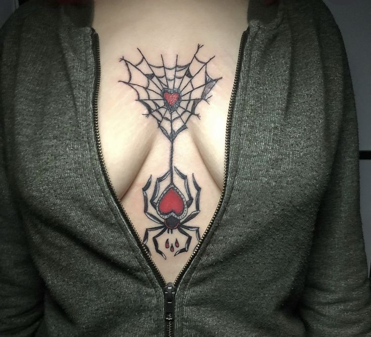 a woman's back with a spider web tattoo on her upper half and chest