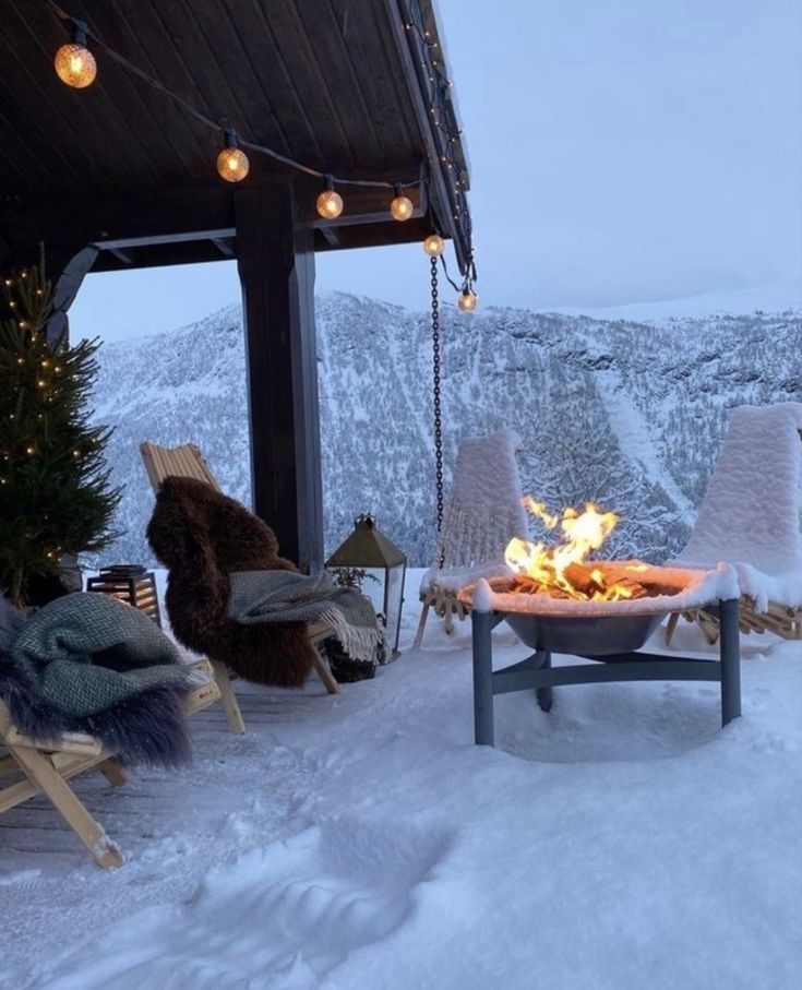 a fire pit sitting on top of a snow covered slope