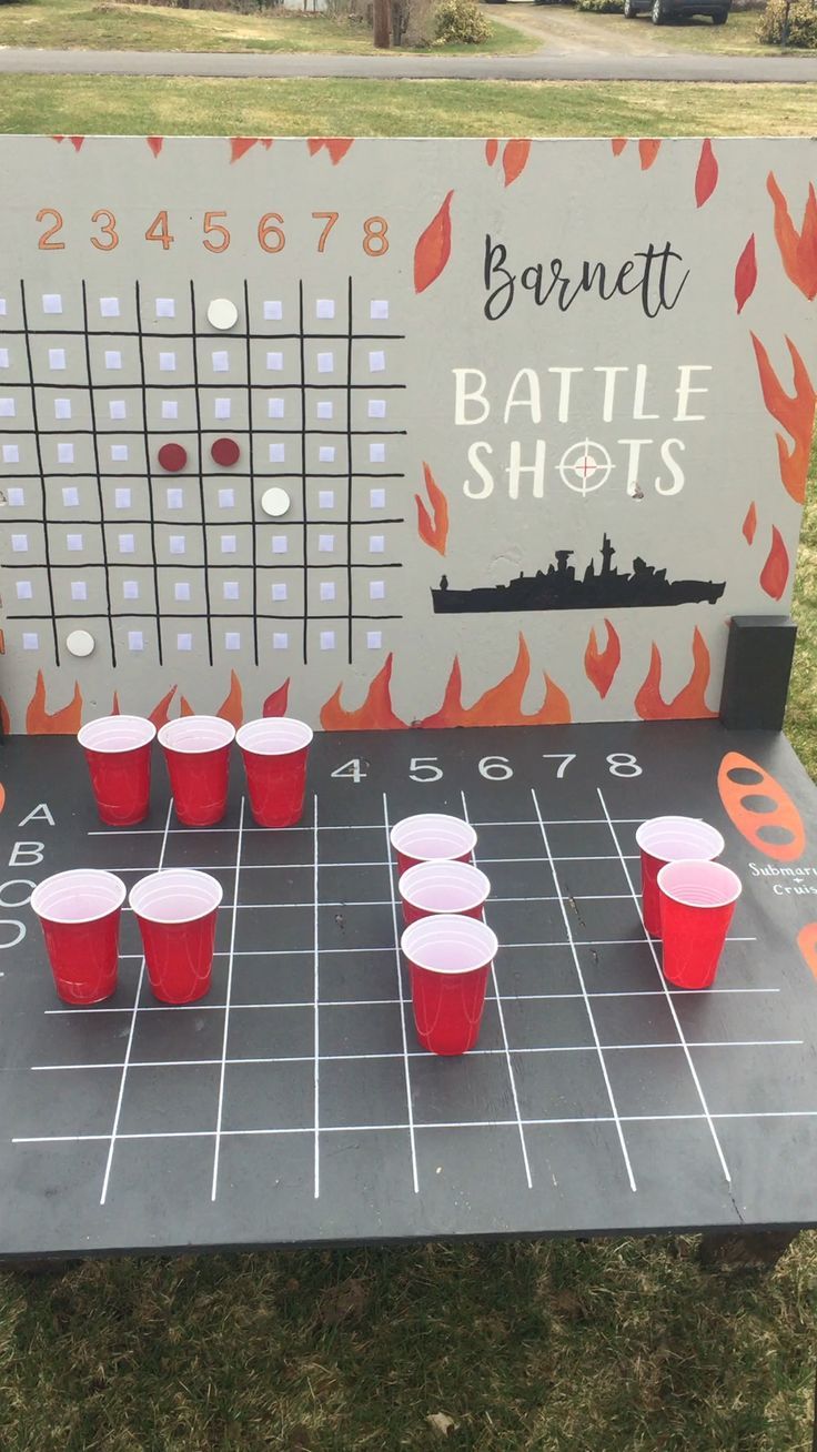 a board game set up with cups on it and the names of battle shots written on it