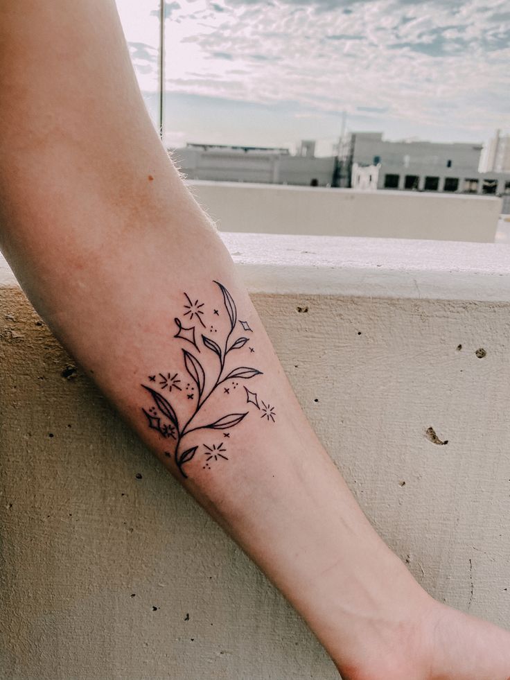 a woman's foot with a flower tattoo on the left side of her leg