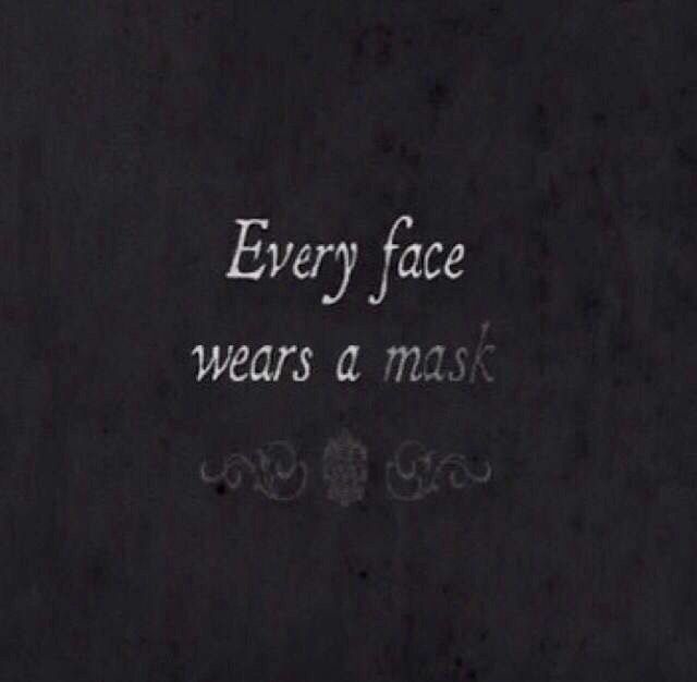 the words every face wears a mask are written in white chalk on a black background