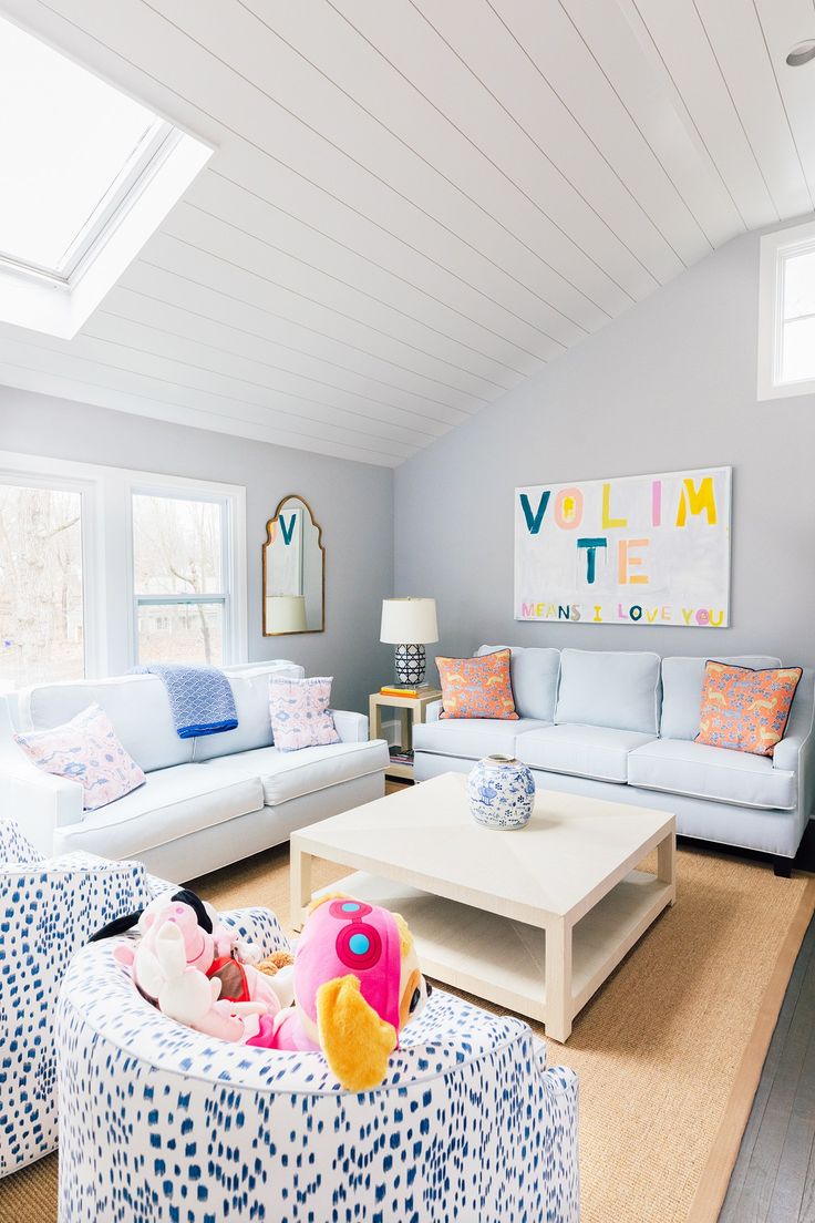 a living room with couches, chairs and a baby doll in the center table