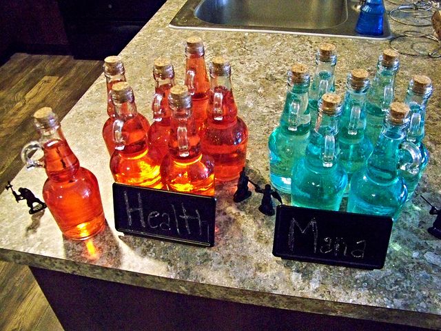 there are many bottles on the counter with their name written on them in black letters