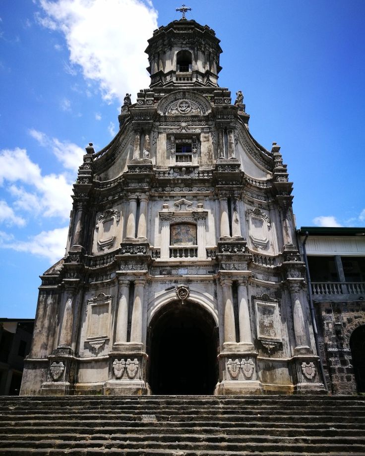 an old church with steps leading up to it