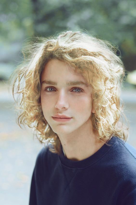 a close up of a person with curly hair