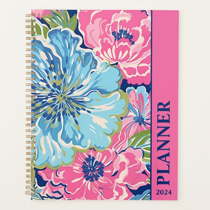 a planner with flowers on it and the words planner written in blue, pink, and green