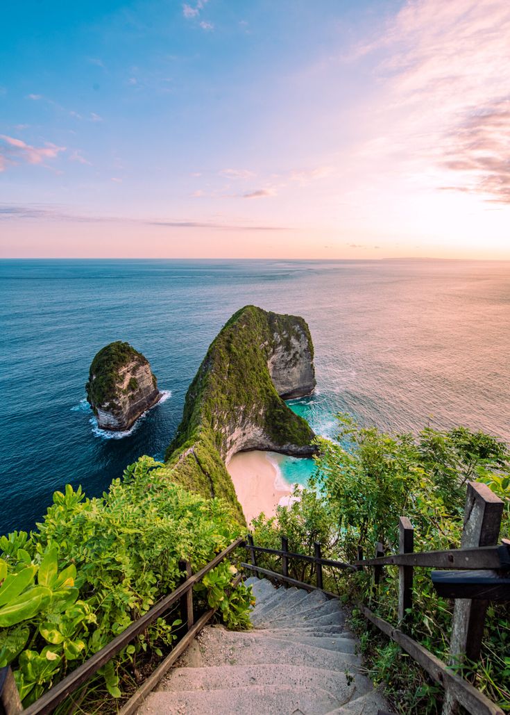 stairs leading down to the beach at sunset in nusa penta, bali island