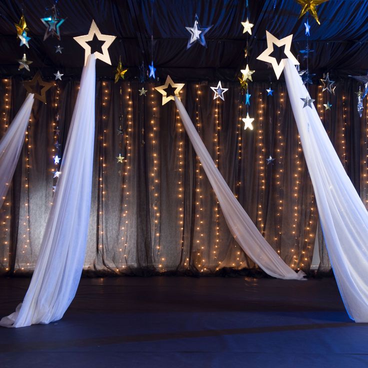 the stage is decorated with stars and drapes