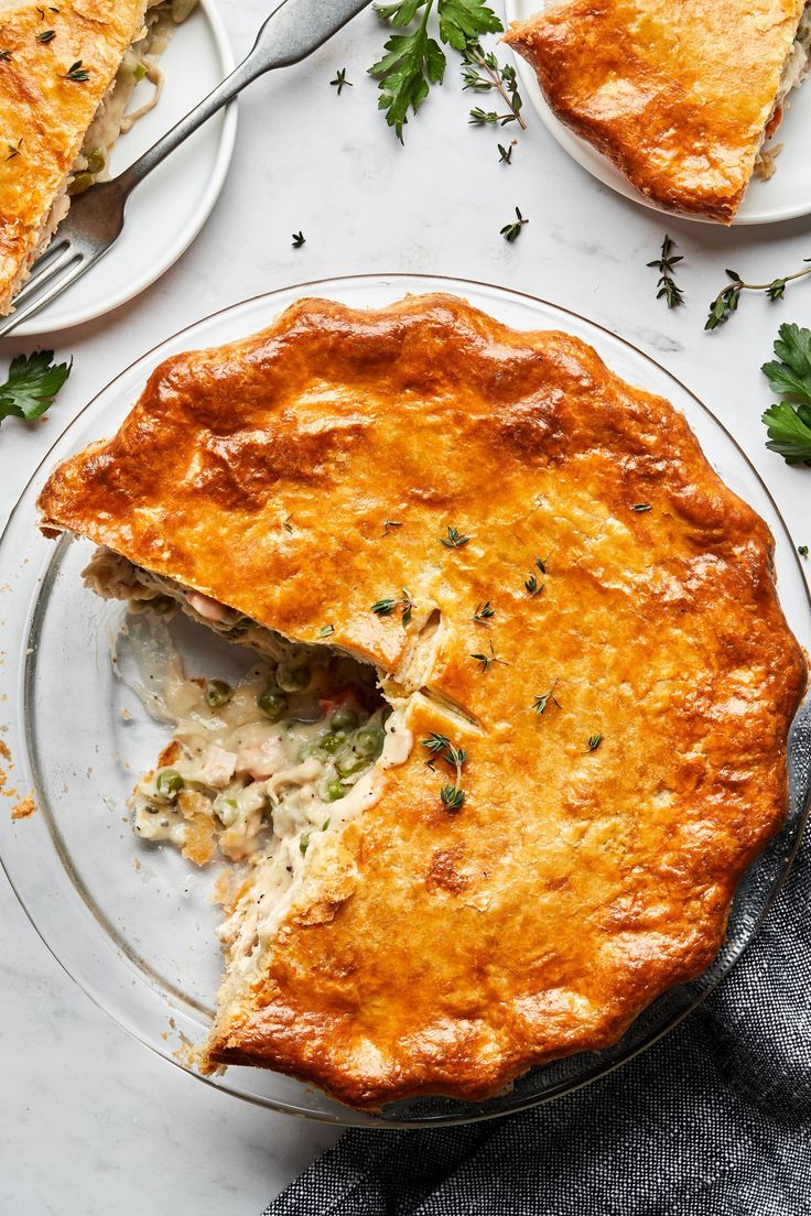 a chicken pot pie is cut in half on a plate