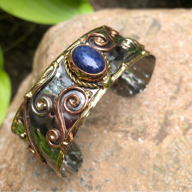 a close up of a bracelet on a rock